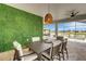 Inviting patio with accent wall overlooking the pool and lake at 7859 Yale Harbor Dr, Wesley Chapel, FL 33545