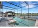 Enjoy this refreshing screened-in pool and lanai with scenic views of the peaceful lake at 7859 Yale Harbor Dr, Wesley Chapel, FL 33545