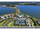 Stunning aerial view of community amenities including tennis courts, pool, clubhouse, and picturesque lakeside homes at 7864 Grande Shores Dr, Sarasota, FL 34240