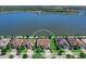 Stunning aerial view of the home on a lake, showcasing its beautiful landscaping and prime location at 7864 Grande Shores Dr, Sarasota, FL 34240