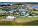 Aerial view of community amenities including a pool, tennis courts, and a sandy beach area at 7864 Grande Shores Dr, Sarasota, FL 34240