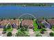 Lakefront home with lush landscaping and a beautiful facade at 7864 Grande Shores Dr, Sarasota, FL 34240