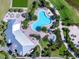 Aerial view of a community clubhouse, pool, spa, and surrounding landscaping at 7864 Grande Shores Dr, Sarasota, FL 34240