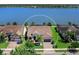 Aerial view of a lovely single Gathering home on a lake with lush landscaping at 7864 Grande Shores Dr, Sarasota, FL 34240