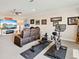 Entertainment area includes a comfy brown sofa, exercise equipment, and a TV - great for Gathering gatherings at 7864 Grande Shores Dr, Sarasota, FL 34240