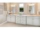 Bright bathroom featuring double sinks, decorative mirrors, and granite counters, offering a luxurious feel at 7864 Grande Shores Dr, Sarasota, FL 34240