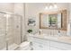 Modern bathroom featuring a glass-enclosed shower, neutral tones, and an elegant vanity at 7864 Grande Shores Dr, Sarasota, FL 34240