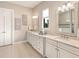 Elegant bathroom with double sinks, granite countertops, and decorative wall art creating a spa-like ambiance at 7864 Grande Shores Dr, Sarasota, FL 34240