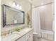 Charming bathroom with a double sink vanity, framed mirror, tub and shower, and stylish decor at 7864 Grande Shores Dr, Sarasota, FL 34240
