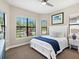 Bright bedroom featuring a large window with garden views, a plush bed, and tasteful decor at 7864 Grande Shores Dr, Sarasota, FL 34240
