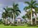 Beautiful clubhouse surrounded by lush landscaping and palm trees at 7864 Grande Shores Dr, Sarasota, FL 34240