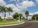 Welcoming community entrance with lush landscaping and clear signage for Shoreview at Waterside at 7864 Grande Shores Dr, Sarasota, FL 34240