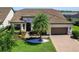 Beautiful home showcasing a tile roof, manicured lawn, and inviting curb appeal at 7864 Grande Shores Dr, Sarasota, FL 34240