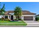 Beautiful single Gathering home featuring a two-car garage, a tile roof, and meticulous landscaping at 7864 Grande Shores Dr, Sarasota, FL 34240