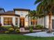 Inviting front entrance with lush landscaping, decorative stone, and a charming walkway at 7864 Grande Shores Dr, Sarasota, FL 34240