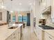 Bright kitchen with stainless steel appliances and stunning waterfront views from the adjacent dining area at 7864 Grande Shores Dr, Sarasota, FL 34240