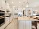 Well-equipped kitchen with a central island, stainless steel appliances, and elegant lighting fixtures at 7864 Grande Shores Dr, Sarasota, FL 34240