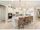 Modern kitchen featuring a large island with seating, stainless steel appliances, and elegant pendant lighting at 7864 Grande Shores Dr, Sarasota, FL 34240