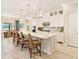 Open kitchen showcasing a central island, ample counter space, and a view to the outdoor dining area at 7864 Grande Shores Dr, Sarasota, FL 34240