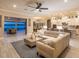 Open-concept living room flows seamlessly into kitchen and patio, offering stunning water views and contemporary design at 7864 Grande Shores Dr, Sarasota, FL 34240
