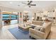 Open-concept living room, kitchen, and dining area with access to patio and water views, perfect for modern living at 7864 Grande Shores Dr, Sarasota, FL 34240