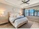 Serene main bedroom featuring a luxurious bed, soft lighting, and a picturesque view of the water at 7864 Grande Shores Dr, Sarasota, FL 34240