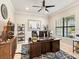 Well-lit office featuring a large desk, comfortable seating, and decorative accents at 7864 Grande Shores Dr, Sarasota, FL 34240