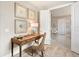 Cozy office nook showcasing a wooden desk, wicker chair, and framed coastal artwork at 7864 Grande Shores Dr, Sarasota, FL 34240