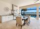 Outdoor kitchen and dining area featuring a stainless steel grill with view to the pool and lake at 7864 Grande Shores Dr, Sarasota, FL 34240