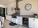 Outdoor kitchen area featuring stainless steel grill, mini fridge, bar, and granite countertops at 7864 Grande Shores Dr, Sarasota, FL 34240