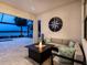 Covered patio with fire pit and comfortable seating, offering stunning lake views for relaxation and entertainment at 7864 Grande Shores Dr, Sarasota, FL 34240