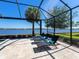 Screened patio with outdoor furniture and a lake view offers a relaxing outdoor space at 7864 Grande Shores Dr, Sarasota, FL 34240