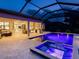 Expansive outdoor patio with summer kitchen, fireplace and pool with spa, ideal for entertaining and relaxing lakeside at 7864 Grande Shores Dr, Sarasota, FL 34240