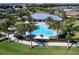 Community pool and clubhouse surrounded by palm trees and lounge chairs at 7864 Grande Shores Dr, Sarasota, FL 34240