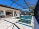 Screened patio with a swimming pool and spa offers an amazing outdoor living experience at 7864 Grande Shores Dr, Sarasota, FL 34240