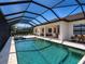 Large screened patio with outdoor pool and spa and seating offers a relaxing outdoor space at 7864 Grande Shores Dr, Sarasota, FL 34240