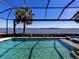 Inviting pool and scenic view create a relaxing oasis in this stunning backyard, perfect for leisure and entertaining at 7864 Grande Shores Dr, Sarasota, FL 34240