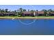 Back of the house view on a lakefront property with well-kept lawn and serene surroundings at 7864 Grande Shores Dr, Sarasota, FL 34240