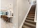 Carpeted staircase with a white banister leads to the upper level of this beautifully designed home at 7864 Grande Shores Dr, Sarasota, FL 34240