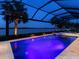 Beautiful screened-in pool and spa overlooking the lake, perfect for relaxation and enjoying the waterfront scenery at 7864 Grande Shores Dr, Sarasota, FL 34240