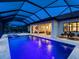 Stunning screened-in pool and spa area with ample seating, providing a luxurious outdoor retreat and water views at 7864 Grande Shores Dr, Sarasota, FL 34240