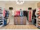 Spacious walk-in closet with custom shelving, ample storage, and a stylish chandelier for elevated organization at 7864 Grande Shores Dr, Sarasota, FL 34240