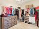 Organized walk-in closet featuring a built-in dresser and shelving units, maximizing storage space at 7864 Grande Shores Dr, Sarasota, FL 34240