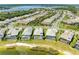 A birds-eye view highlights a home in a lakeside neighborhood near a community lakefront amenity at 8067 Waterbend Trl, Sarasota, FL 34240