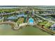 Panoramic aerial view of community featuring a pool, clubhouse, and lakefront access amidst lush landscaping at 8067 Waterbend Trl, Sarasota, FL 34240