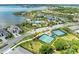 Beautiful aerial view of community amenities including tennis courts and community pool near the lake at 8067 Waterbend Trl, Sarasota, FL 34240
