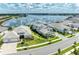Aerial view of a lovely home near the water with lush landscaping and a scenic lake view at 8067 Waterbend Trl, Sarasota, FL 34240