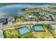 An aerial view shows the community amenities, including the pool, clubhouse, and tennis courts at 8067 Waterbend Trl, Sarasota, FL 34240