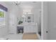 Bright bathroom featuring white cabinetry, marble countertops, and a glass-enclosed shower at 8067 Waterbend Trl, Sarasota, FL 34240