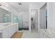 Spacious bathroom with double sinks, marble countertops, and a glass shower enclosure at 8067 Waterbend Trl, Sarasota, FL 34240
